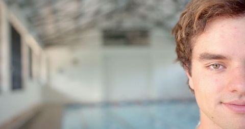 Close-up of Male Swimmer with Indoor Pool Background