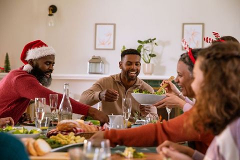Diverse friends celebrating around festive dining table