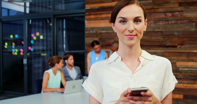 Confident Businesswoman Using Smartphone in Modern Office - Download Free Stock Images Pikwizard.com