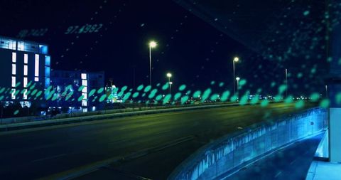 Turquoise night overpass with empty highway, wet glass reflections and bokeh streetlights