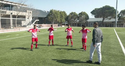Soccer Coach Directing Team During Practice Session