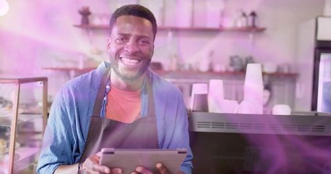 Friendly African American Barista Using Tablet in Modern Café