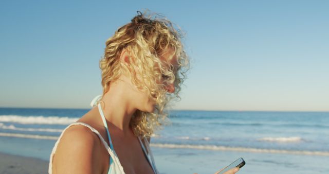 Woman with Curly Hair Using Smartphone on Beach - Download Free Stock Images Pikwizard.com