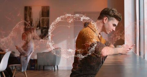 Man using smartphone in café with digital network overlay