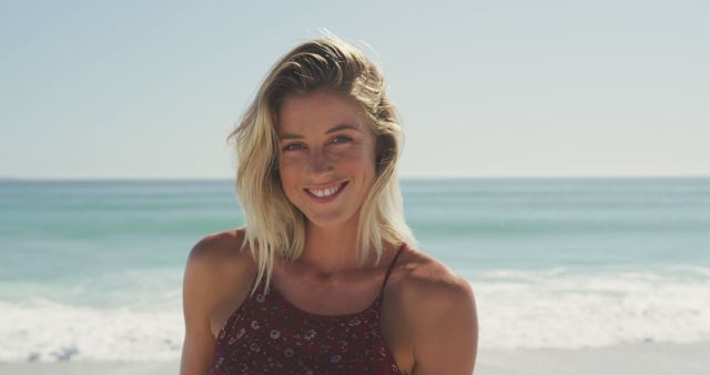 Smiling Blonde Woman Posing by Sea Shore on Sunny Day - Download Free Stock Images Pikwizard.com
