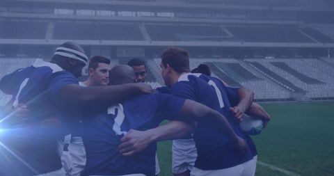 Rugby Team Huddling in Foggy Stadium Ambiance