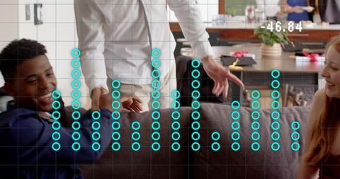 Friends reaching and laughing on living room couch with turquoise digital data overlay