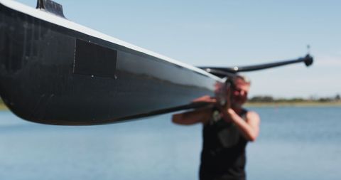 Senior Man Carrying Rowing Boat Near Lake - Download Free Stock Images Pikwizard.com