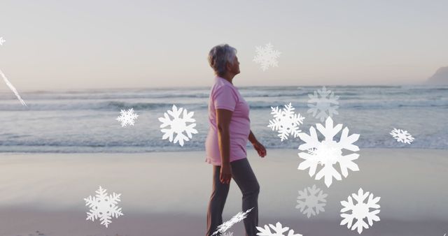 Senior Woman Walking on Beach with Digital Snowflakes - Download Free Stock Images Pikwizard.com