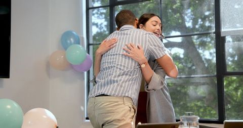 Business colleagues celebrating birthday at office party with cake