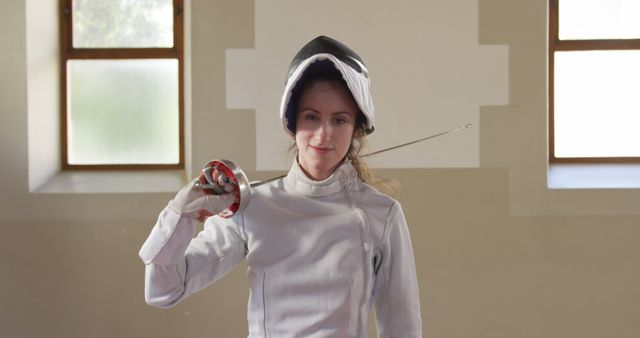 Female Fencer Holding Foil Saber in Training Hall - Download Free Stock Images Pikwizard.com