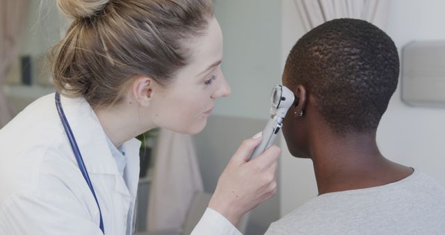 Doctor Examining Patient's Ear with Otoscope in Medical Center - Download Free Stock Images Pikwizard.com