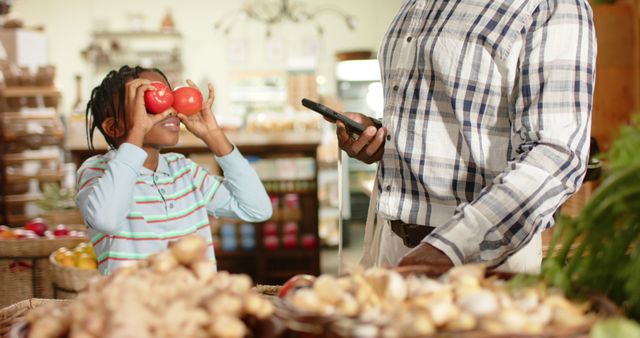 Father and Son Grocery Shopping, Playful Moment with Fruits - Download Free Stock Images Pikwizard.com