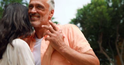 Smiling Couple Joyfully Dancing Outdoors