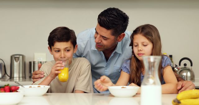 Father and Children Enjoying Breakfast in Kitchen - Download Free Stock Images Pikwizard.com