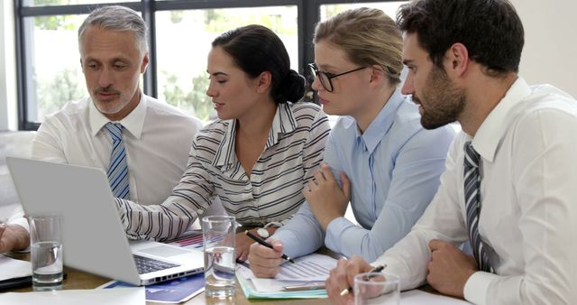 Team Meeting with Businesspeople Discussing Strategies on Laptop - Download Free Stock Images Pikwizard.com