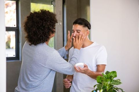Friends Enjoying Skincare Routine in Modern Bathroom