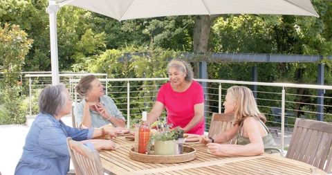 Senior Women Enjoying Outdoor Gathering Under Umbrella - Download Free Stock Images Pikwizard.com