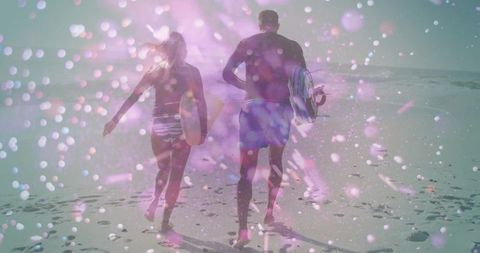 Dreamy double exposure couple walking on beach with surfboards and pastel bokeh light