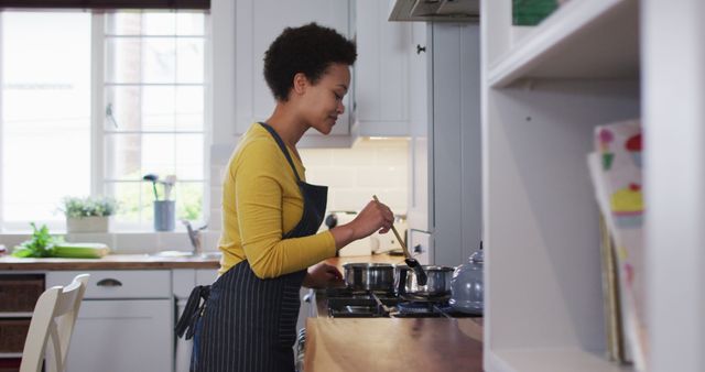 Smiling Woman Cooking at Home in Modern Kitchen - Download Free Stock Images Pikwizard.com