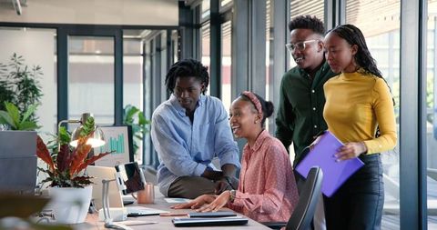 Team Analyzing Data on Computer in Modern Office