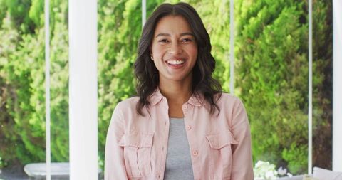 Smiling Biracial Woman Relaxing Outdoors on Patio