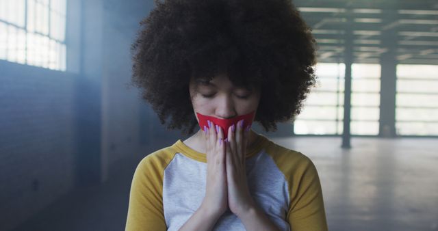 Woman with Red Tape Over Mouth, Eyes Closed, Hands Together in Silent Protest - Download Free Stock Images Pikwizard.com