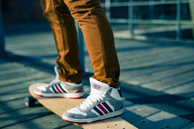 Person Skateboarding with Sneakers on Wooden Deck - Download Free Stock Photos Pikwizard.com