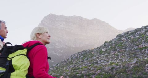 Senior Couple Trekking through Mountain Landscape