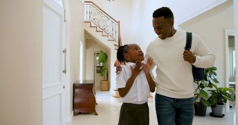 Joyful Reunion of Father and Daughter in Home Entrance