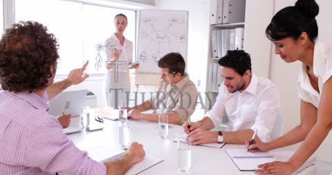 Business Team in Engaging Meeting with Accompanying Charts and Data