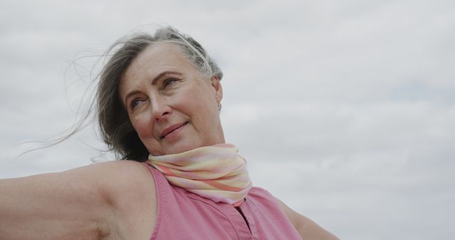 Smiling Elderly Woman Wearing Scarf on Cloudy Day - Download Free Stock Images Pikwizard.com