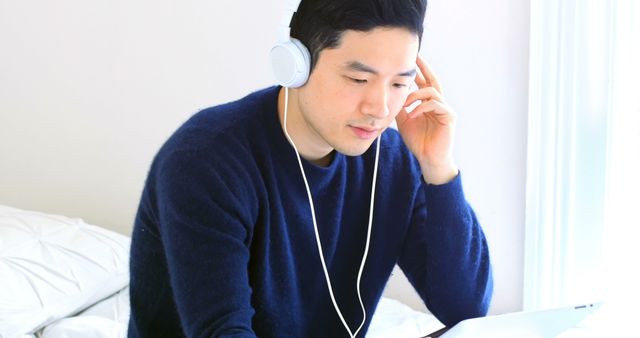 Man Wearing Headphones Using Laptop at Home - Download Free Stock Images Pikwizard.com