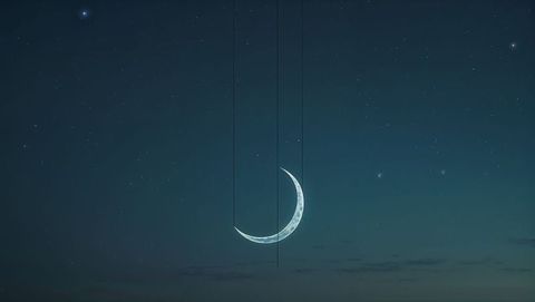 Shimmering crescent moon among starlit night sky