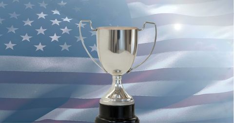 Silver Trophy with American Flag Background Represents Victory