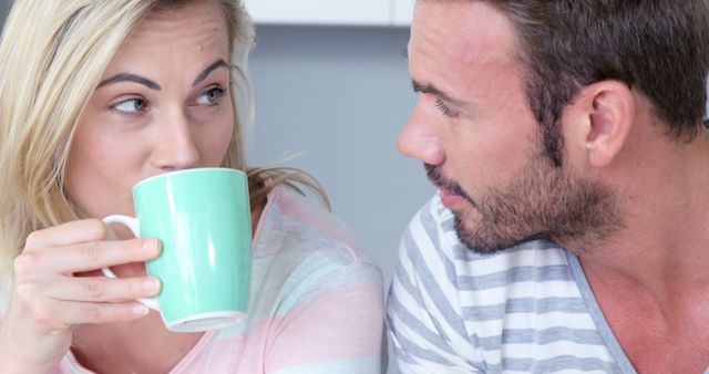 Cute couple drinking coffee together in the kitchen - Download Free Stock Photos Pikwizard.com
