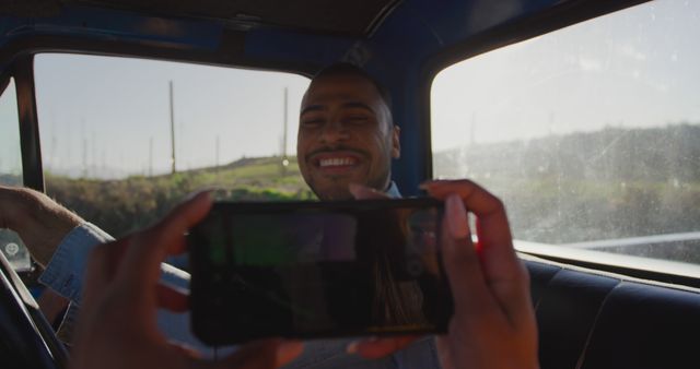 Smiling Man Being Photographed on Road Trip in Car - Download Free Stock Images Pikwizard.com