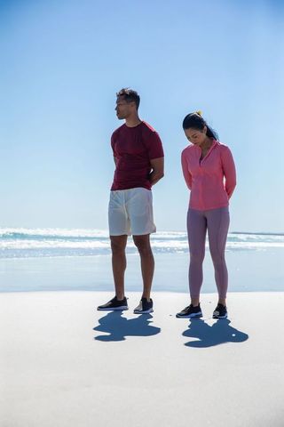 Friends Enjoy Beach Adventure in Stylish Athletic Attire
