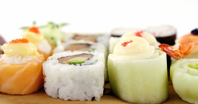 Assorted Fresh Sushi Rolls with Various Toppings on Wooden Board - Download Free Stock Images Pikwizard.com