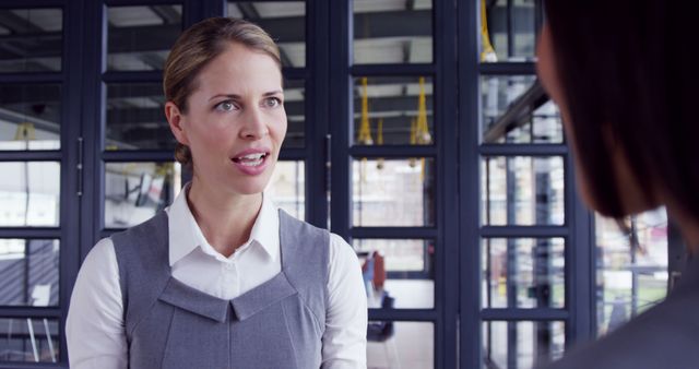 Professional Woman Discussing in Modern Office Environment - Download Free Stock Images Pikwizard.com