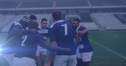Unified Rugby Team Huddling on Field Preparing for Match