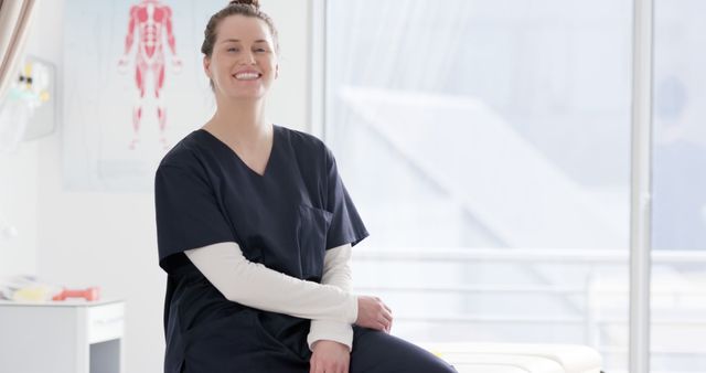 Nurse smiling while sitting in a bright and modern medical office. Medical chart on wall behind her suggests an environment focused on health and patient care. Ideal for illustrating medical professions, healthcare environments, or promotional material for medical institutions. Use in health-related articles, advertisements, or educational content about medical careers.