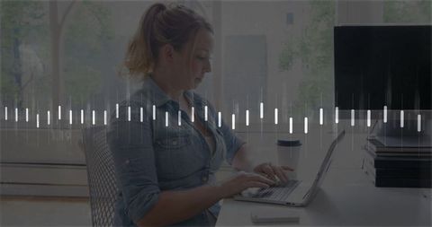 Woman typing at laptop in modern home office