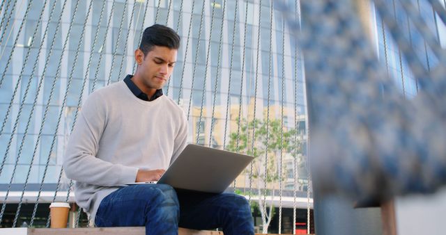 Young Professional Working on Laptop Outdoors - Download Free Stock Images Pikwizard.com