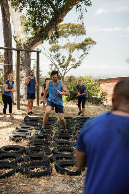 Man receiving tire obstacle course training in boot camp