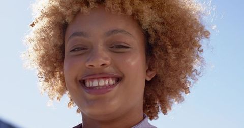 Sunlit Young Woman Smiling Outdoors Radiant Natural Headshot Portrait Embracing Joy