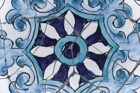 Intricate blue and white ceramic tile with detailed patterns