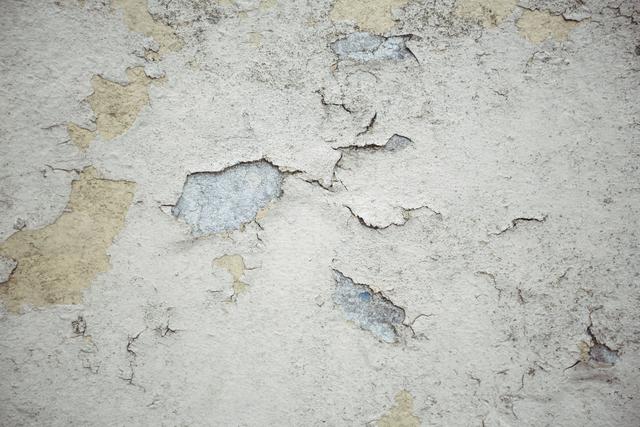 This image of an old wall with peeled plaster texture is ideal for use in design projects requiring a vintage or distressed look. It can be used as a background for graphic design, websites, or presentations. The weathered and cracked surface adds a rustic and aged feel, making it suitable for themes related to decay, history, or architecture.
