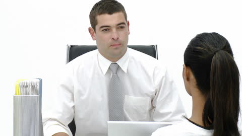 Manager Discussing with Employee in Formal Office Setting