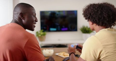 Diverse Male Friends Enjoying Video Games Indoors